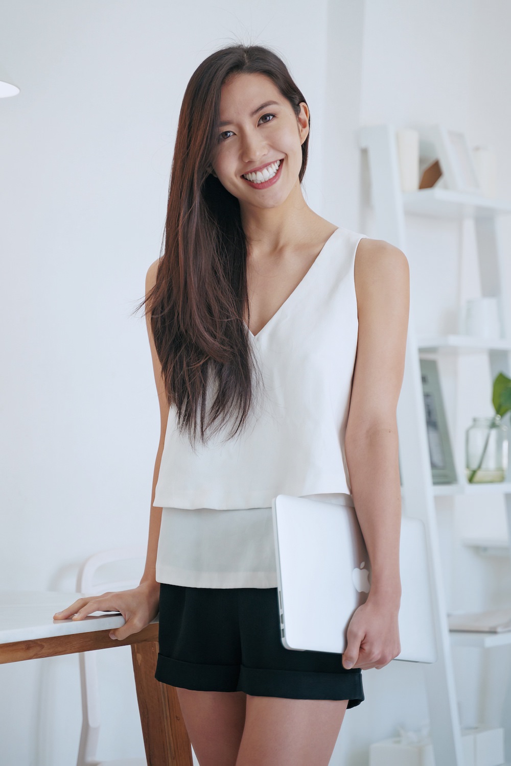 woman-holding-laptop-beside-table